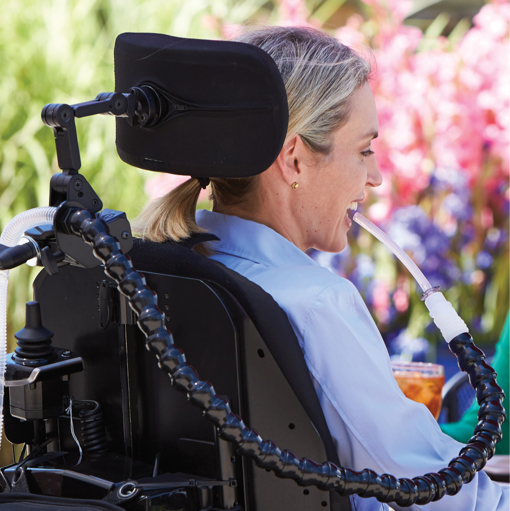 Woman using ventilator in wheelchair