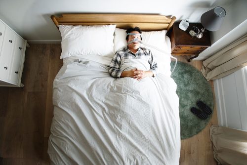 Man sleeping with a CPAP mask