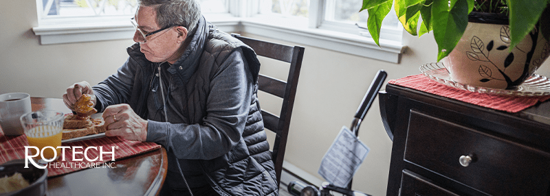 Man sitting at the table with an oxygen tank
