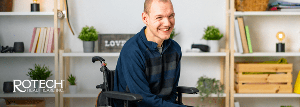 Man smiling and sitting in wheelchair in his home