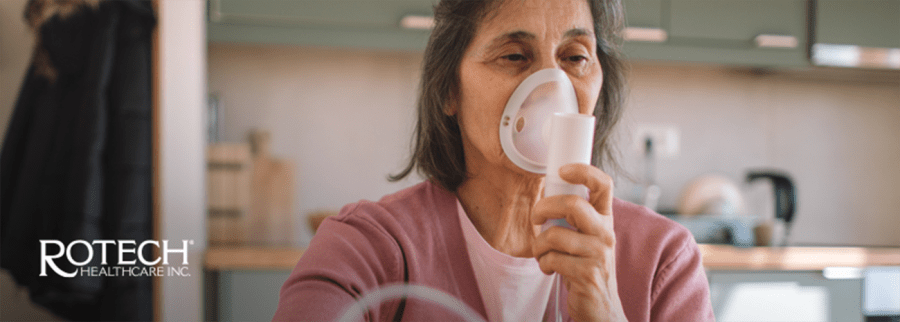 Woman using an oxygen mask in her home