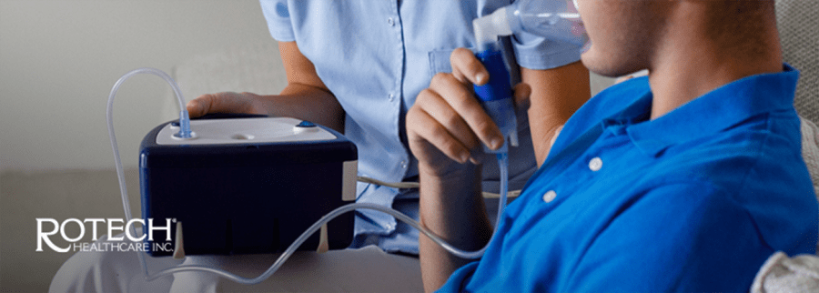 Person receiving oxygen from ventilator in their home with healthcare professional in the background