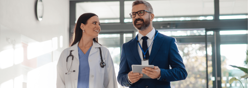 Two healthcare professionals walking and smiling