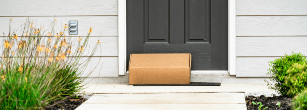 Product delivered in box in front of front door of a house