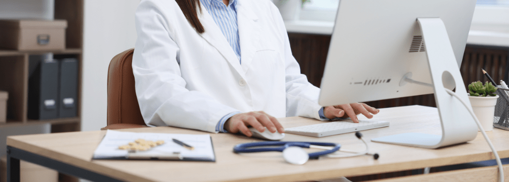 Female doctor using desktop computer