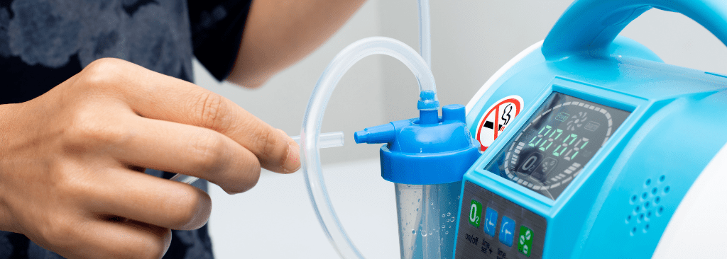 Person setting up tubing inside of an oxygen concentrator