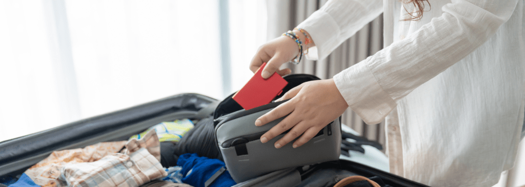 Woman packing items into her suitcase