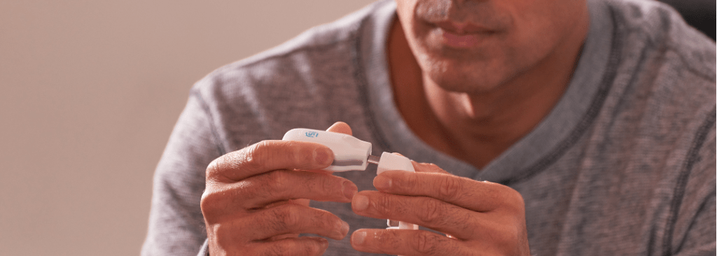 Man setting up eXciteOSA device in his hands
