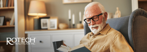 Senior man sitting in chair reading book