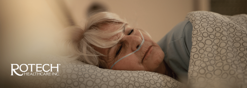 Woman lying sideways in bed with oxygen cannula in nose