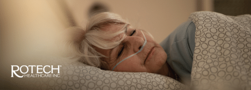 Woman lying sideways in bed with oxygen cannula in nose