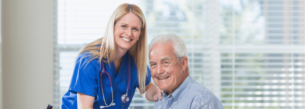 Female healthcare professional setting up oxygen cannula for senior man at home
