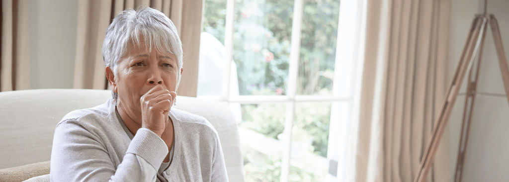 Senior woman coughing